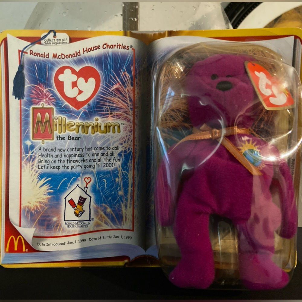 Retired TY Beanie Baby: Millennium The Bear in sealed package.